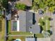 An aerial view of the property showcasing the pool, patio, and well-maintained landscaping at 16605 Round Oak Dr, Tampa, FL 33618