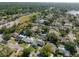 Wide aerial shot featuring the property in a neighborhood surrounded by lush greenery and lakes at 16605 Round Oak Dr, Tampa, FL 33618