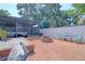 Spacious backyard with brick-paved patio, pergola-covered seating, fire pit, and well-maintained landscaping at 16605 Round Oak Dr, Tampa, FL 33618