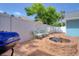 Charming backyard featuring a brick fire pit, comfortable seating, and well-maintained landscaping, creating a relaxing outdoor space at 16605 Round Oak Dr, Tampa, FL 33618