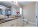 Stylish bathroom featuring a marble countertop, elegant fixtures, and a glass-enclosed shower at 16605 Round Oak Dr, Tampa, FL 33618