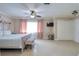 This spacious bedroom features neutral tones, a ceiling fan, and access to the en suite at 16605 Round Oak Dr, Tampa, FL 33618