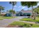 Exterior view highlighting the home's stylish facade, colorful entry, and brick-paved driveway at 16605 Round Oak Dr, Tampa, FL 33618