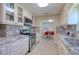 Kitchen features stainless appliances, granite countertops, white cabinets and dining area in background at 16605 Round Oak Dr, Tampa, FL 33618