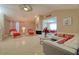 Spacious living room featuring tile flooring, vaulted ceilings, and a comfortable seating area with modern decor at 16605 Round Oak Dr, Tampa, FL 33618