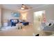 Bright living room featuring tile floors, a blue sofa, stylish decor, and an open doorway to adjacent room at 16605 Round Oak Dr, Tampa, FL 33618
