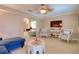 Living room with stylish seating arrangements, tile floors, a TV, and an open layout leading to other living spaces at 16605 Round Oak Dr, Tampa, FL 33618