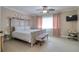 Bright main bedroom with tile floors, ceiling fan, and neutral walls at 16605 Round Oak Dr, Tampa, FL 33618