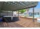 Well-designed backyard with brick-paved patio, pergola-covered lounge area, fire pit, and ample space for outdoor enjoyment at 16605 Round Oak Dr, Tampa, FL 33618
