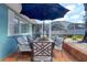 Charming outdoor patio with dining set and views of the screened pool area and lush backyard, ideal for relaxation at 16605 Round Oak Dr, Tampa, FL 33618