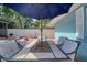 Outdoor dining area with umbrella-covered table and chairs, perfect for enjoying meals in the landscaped backyard at 16605 Round Oak Dr, Tampa, FL 33618