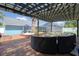 Inviting outdoor patio with pergola, brick flooring, and cozy seating area, perfect for relaxing and entertaining at 16605 Round Oak Dr, Tampa, FL 33618