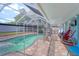 Relaxing screened-in pool area with a safety fence and ample space for outdoor lounging at 16605 Round Oak Dr, Tampa, FL 33618