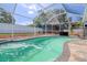 Backyard swimming pool area, screened-in for privacy and comfort, complete with outdoor seating and lounging space at 16605 Round Oak Dr, Tampa, FL 33618