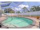 Inviting in-ground pool with clear water, tile border, safety features, and patio space for entertaining at 16605 Round Oak Dr, Tampa, FL 33618
