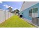 Well-maintained side yard with lush lawn and privacy fence, perfect for outdoor activities, surrounded by mature trees at 16605 Round Oak Dr, Tampa, FL 33618