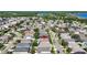 Aerial neighborhood view highlights home's location, proximity to a lake, trees, and nearby streets with residences at 16802 Fairbolt Way, Odessa, FL 33556