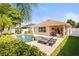 Charming backyard with a private pool, patio, lounge chairs and beautiful landscaping, ideal for outdoor living at 16802 Fairbolt Way, Odessa, FL 33556
