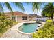 Beautiful pool surrounded by lush landscaping and a paved deck creating a private oasis for relaxation and enjoyment at 16802 Fairbolt Way, Odessa, FL 33556