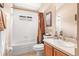 Bathroom with wood vanity, shower-tub combo, and lots of light at 16802 Fairbolt Way, Odessa, FL 33556