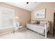 Adorable bedroom with a day bed, ceiling fan and a window with plantation shutters at 16802 Fairbolt Way, Odessa, FL 33556