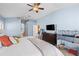 Spacious bedroom with en suite bathroom, ceiling fan, and neutral wall color at 16802 Fairbolt Way, Odessa, FL 33556