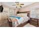 Inviting bedroom with wood furniture, ceiling fan and plantation shutters at 16802 Fairbolt Way, Odessa, FL 33556