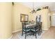 Dining room with a round table, seating for six, decorative art, and a stylish chandelier at 16802 Fairbolt Way, Odessa, FL 33556