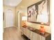 Welcoming foyer with wood floors, stylish console table, lamps and decorative artwork at 16802 Fairbolt Way, Odessa, FL 33556