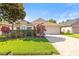 Charming single-story home featuring manicured landscaping and a brick-paved driveway at 16802 Fairbolt Way, Odessa, FL 33556