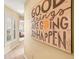 Hallway featuring wood floors, bright wall art and natural light at 16802 Fairbolt Way, Odessa, FL 33556