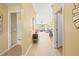 Hallway featuring wood floors and views of the living and dining areas at 16802 Fairbolt Way, Odessa, FL 33556