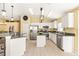 Open concept kitchen features granite countertops, stainless appliances, and breakfast bar with island at 16802 Fairbolt Way, Odessa, FL 33556