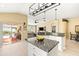 Well-lit kitchen featuring granite countertops, center island and open view to the adjacent living areas at 16802 Fairbolt Way, Odessa, FL 33556