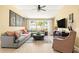 Open-concept living room featuring contemporary decor and comfortable seating, complemented by natural light at 16802 Fairbolt Way, Odessa, FL 33556