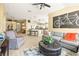 Spacious living room featuring a large sofa and open access to the kitchen and dining area at 16802 Fairbolt Way, Odessa, FL 33556