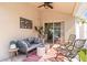 Comfortable covered patio with a ceiling fan, sliding glass doors, stylish seating, and decorative accents at 16802 Fairbolt Way, Odessa, FL 33556