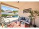 Inviting covered patio features stylish seating, decor and overlooks a sparkling pool, perfect for outdoor relaxation at 16802 Fairbolt Way, Odessa, FL 33556
