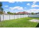 Spacious backyard with a well-maintained lawn and white fence at 1755 Open Field Loop, Brandon, FL 33510