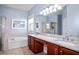 Bright bathroom with double sinks, a soaking tub, and separate shower at 1755 Open Field Loop, Brandon, FL 33510