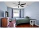 Comfortable bedroom with hardwood floors, ceiling fan, and plenty of natural light at 1755 Open Field Loop, Brandon, FL 33510