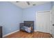 Comfortable bedroom with hardwood floors, closet and a wooden crib at 1755 Open Field Loop, Brandon, FL 33510