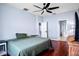 Spacious bedroom featuring hardwood floors and ensuite bathroom with ceiling fan at 1755 Open Field Loop, Brandon, FL 33510