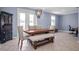 Light-filled dining room featuring a wooden table with bench seating and stylish chandelier at 1755 Open Field Loop, Brandon, FL 33510