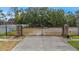 Gated entrance with stone pillars and black iron gates at 1755 Open Field Loop, Brandon, FL 33510
