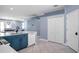 Open kitchen design with blue lower cabinets, white countertops, tile flooring, and white appliances at 1755 Open Field Loop, Brandon, FL 33510