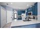 Bright kitchen featuring blue cabinets, white countertops, tile backsplash, and modern fixtures at 1755 Open Field Loop, Brandon, FL 33510