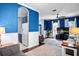 Open-concept living area with seamless flow to kitchen, blue walls, and neutral furniture at 1755 Open Field Loop, Brandon, FL 33510