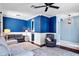 Bright living room with blue walls, white trim, hardwood floors, and stylish decor at 1755 Open Field Loop, Brandon, FL 33510