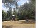 Community playground featuring a slide, swings, and benches surrounded by mature trees at 1755 Open Field Loop, Brandon, FL 33510